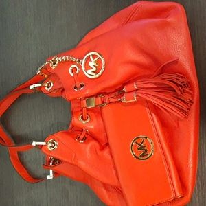 Michael Kors red leather shoulder bag and wallet never used.2 small wallet marks